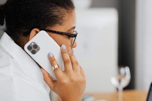 Tenant holding a phone to their ear while making a call from home