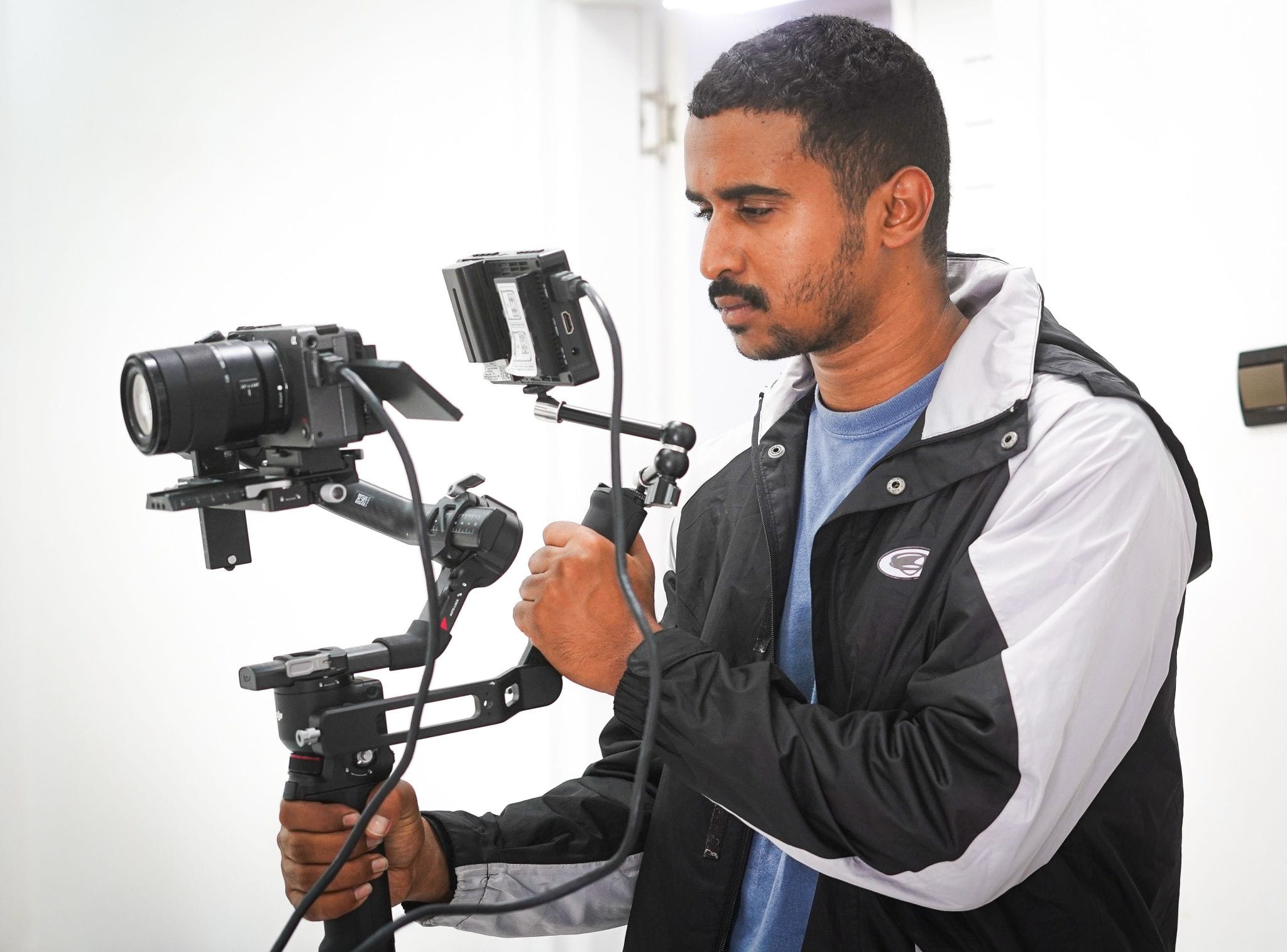 Real estate photographer steadying a camera on a gimbal while documenting a property